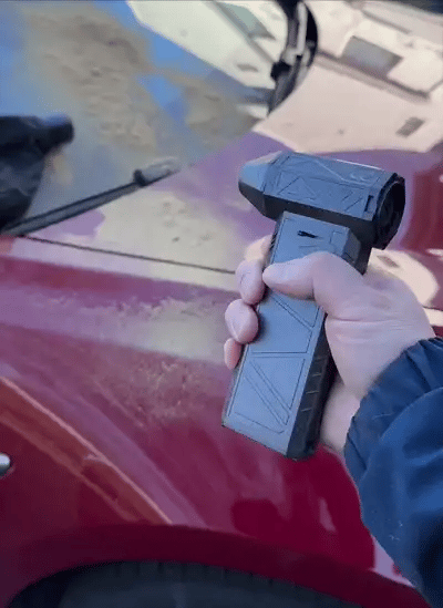 point of view perspective of someone using a blowy v3 power blower blowing dust off of a dirty car