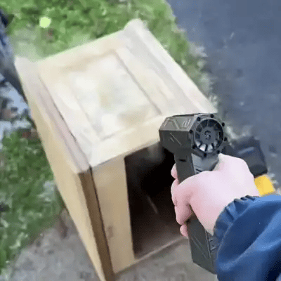 blowy handheld power blower blowing away dust of a bench 